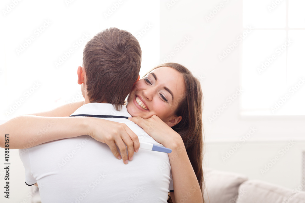 Young couple happy about results of pregnancy test Young couple happy about results of pregnancy test