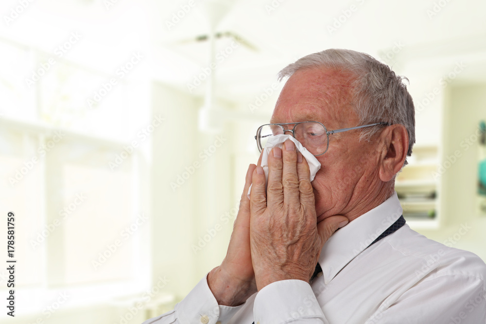 Senior business man Sneezing into Tissue. Flu, Allergy, Runny Nose