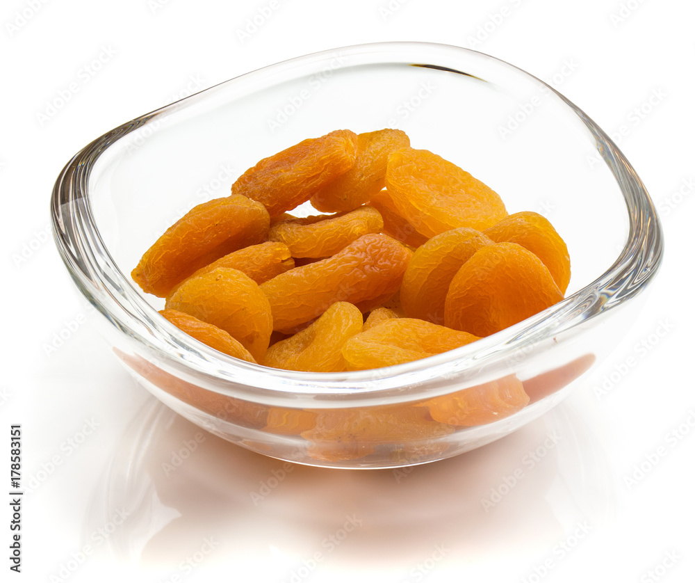 Dried apricots in crystal bowl isolated on white background Dried apricots in crystal bowl isolated on white background