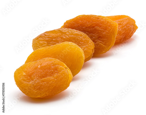 Dried apricots in row isolated on white background photo