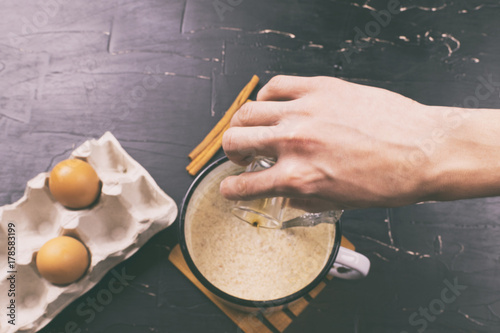 A man prepares eggnog