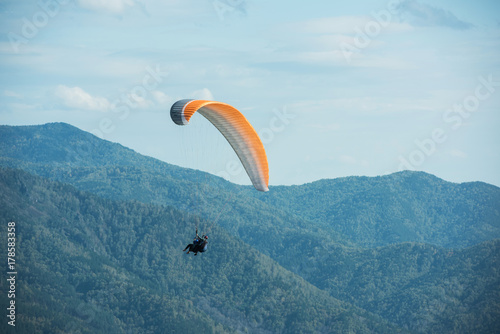 Paragliding in mountains. Para gliders in fight in the mountains, extreme sport activity.