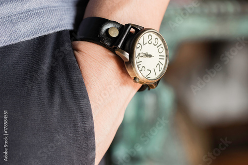 Man wearing old watch on left wrist