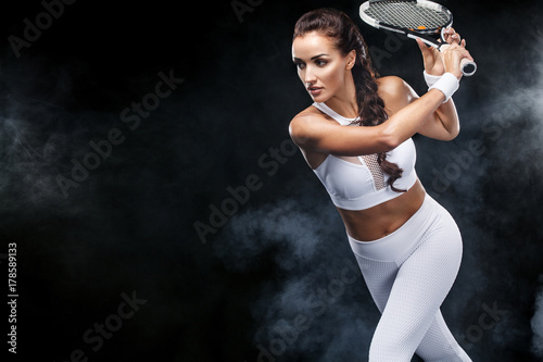 Beautiful sport woman tennis player with racket in white sportswear costume