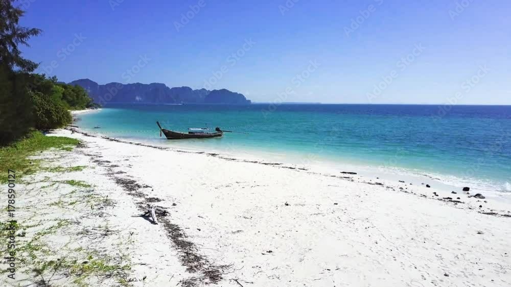 Long-tail boat on a beautiful beach at island in Krabi Thailand Long-tail boat on a beautiful beach at island in Krabi Thailand