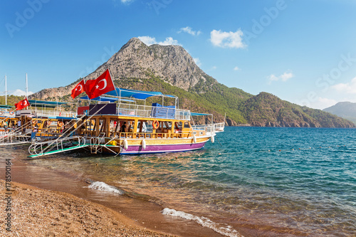Fototapeta Naklejka Na Ścianę i Meble -  Panoramic view of the coastal beach with cruise ships with turkish flags waiting for tourists