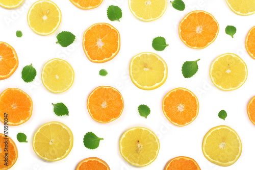 Slices of orange or tangerine and lemon with mint leaves isolated on white background. Flat lay, top view