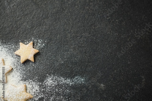 Directly above shot of star shape cookies with pastry cutter