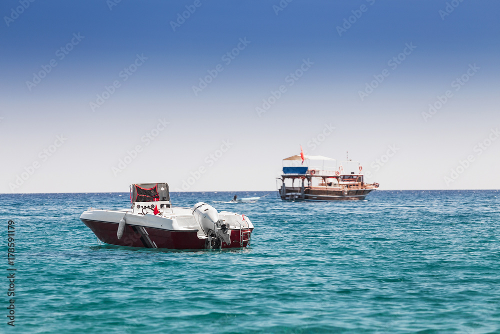 Fototapeta premium a motor boat stands in a sea bay, the concept of passenger transport in the beach resort