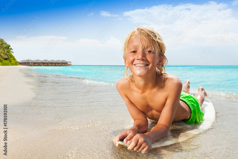Happy boy on surfboard near the sea Happy boy on surfboard near the sea