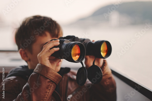 Little boy watching, looking, gazing, searching for by binoculars during trip © sakkmesterke