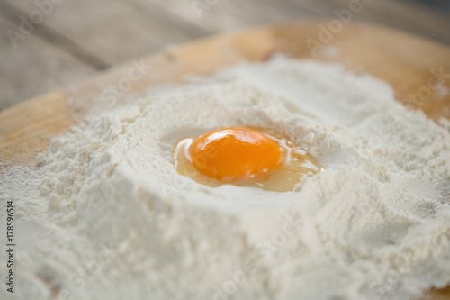 Close up of egg yolk in flour on cutting board