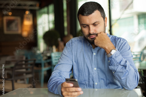 Handsome man texting on phone