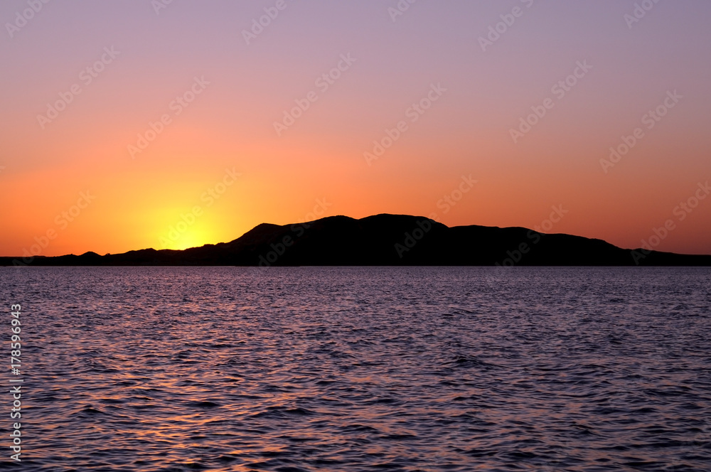 Silhouette of an Island Covering the Sunset