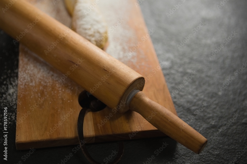 Close up of rolling pin on cutting board
