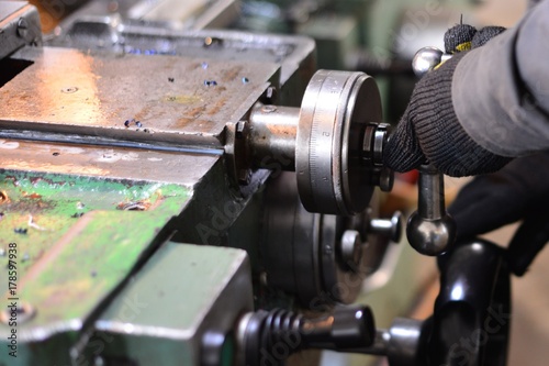 Professional machinist. Horizontal shot of a man operating lathe grinding machine metalworking industry concept copyspace