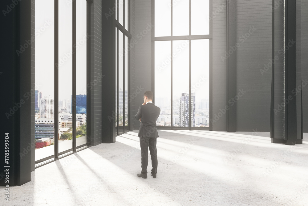 Fototapeta premium Pondering businessman in room