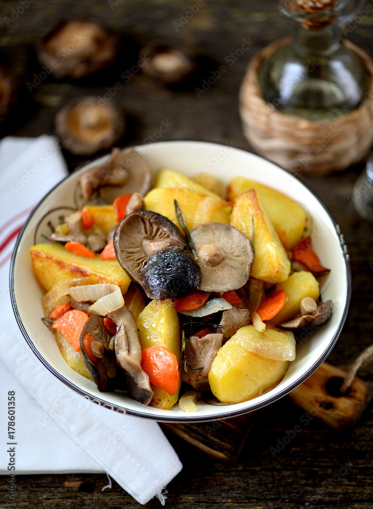 Stewed potatoes with onion, mushrooms, carrot, rosemary and garlic in olive oil. Stewed potatoes with onion, mushrooms, carrot, rosemary and garlic in olive oil.