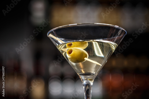Martini cocktail with green olives photo