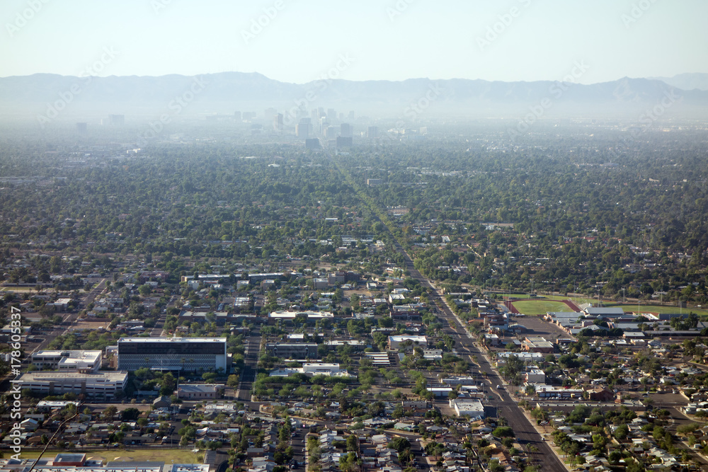 Air pollution from Interstate-10 and I-17 in morning haze above major Arizona city downtown of Phoenix as seen from the top of North Mountain Park hiking trails