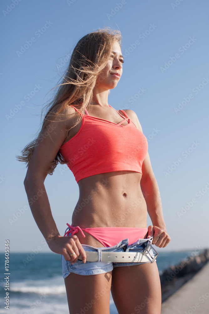Attractive young woman with sagging pants and hands on hips Stock