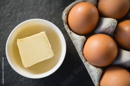 Close up of butter in bowl by egg carton