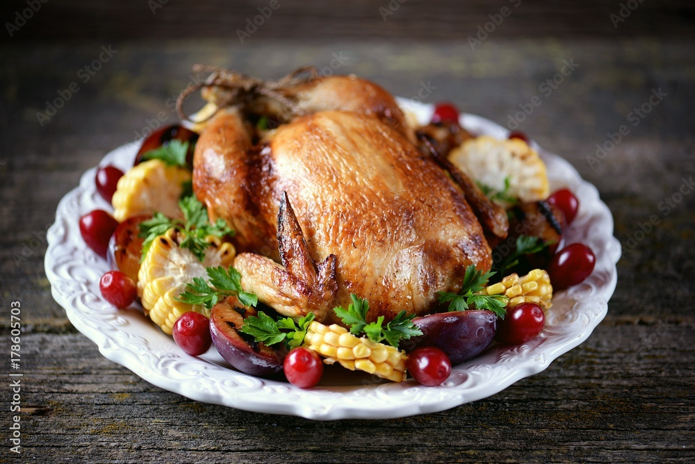 Grilled chicken on Thanksgiving day with corn, plum, dogwood and parsley. Grilled chicken on Thanksgiving day with corn, plum, dogwood and parsley.