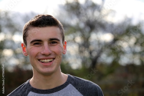 Portrait head shot of a teenage boy smiling
