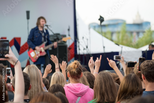 Audience cheering musicians at an open air music festival