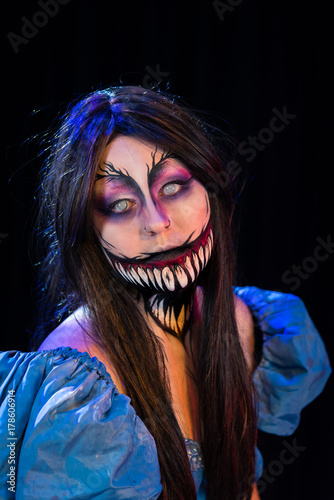What Lies Beneath Female Model with custom special effects makeup on a stage with theatrical lighting. Halloween and horror themed