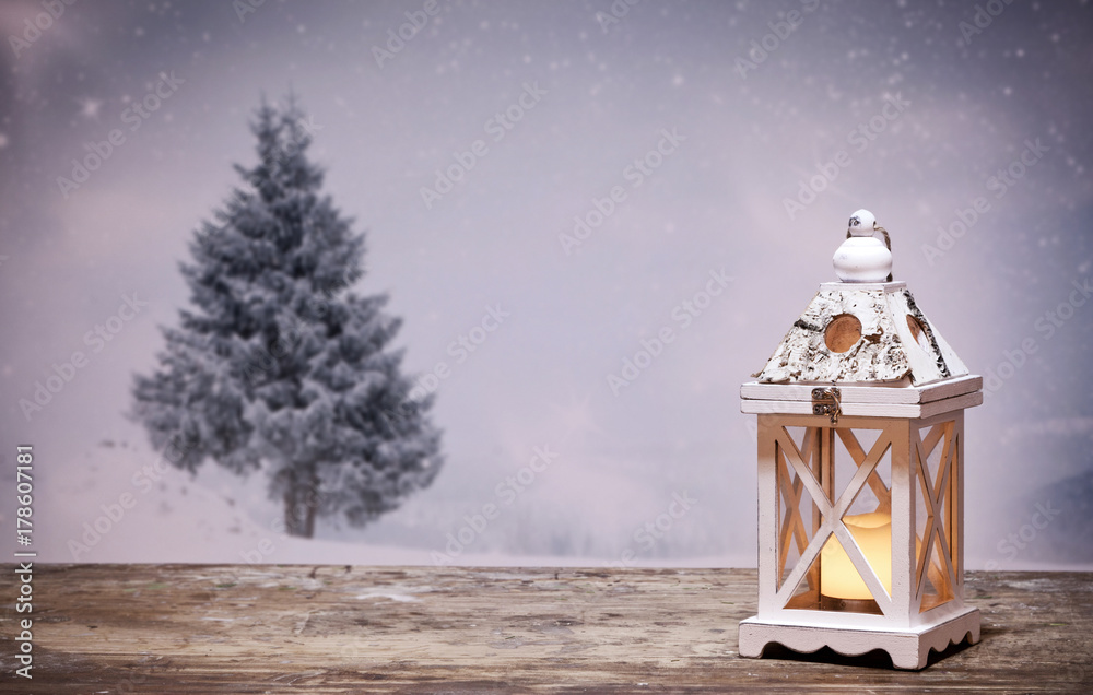 christmas lantern and snowy firs in the background christmas lantern and snowy firs in the background