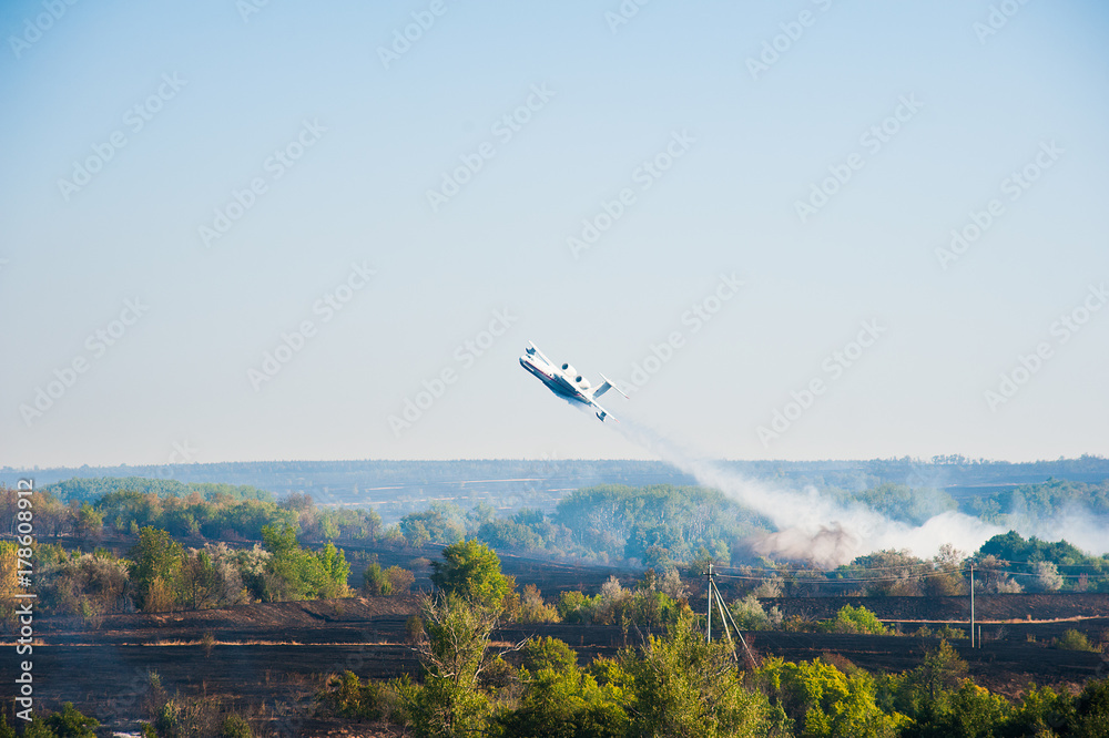 Firefighter airplane extinguishes a forest fire Firefighter airplane extinguishes a forest fire