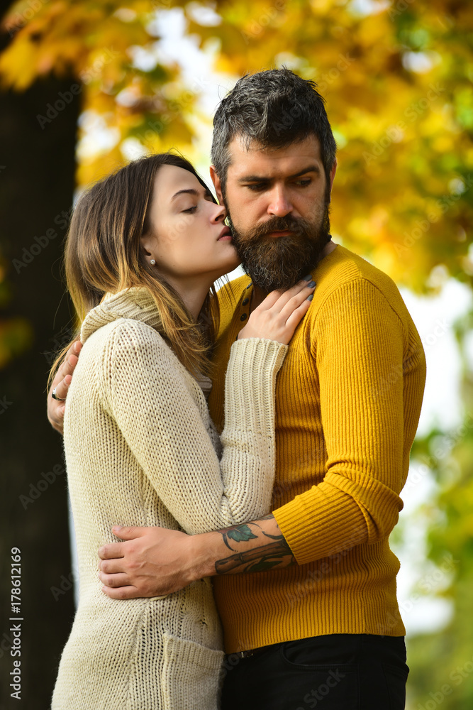 Man and woman at yellow tree leaves