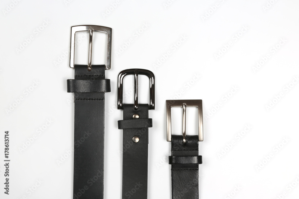 three black leather belt on white background.