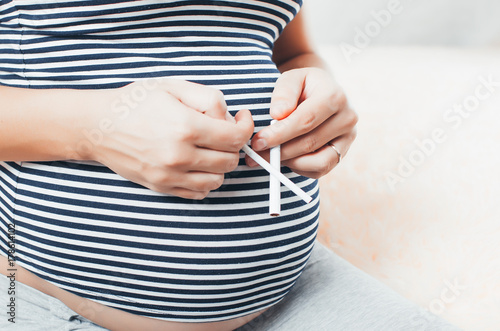 pregnant girl with cigarettes photo