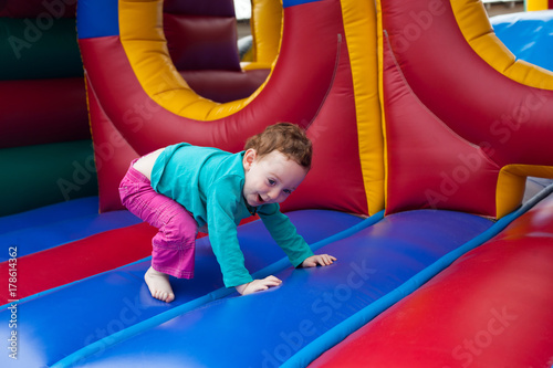 Laughing toddler on trampoline