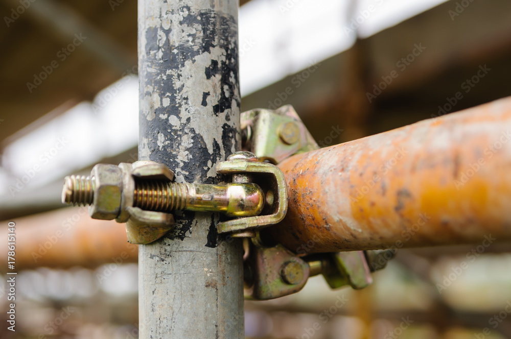Scaffolding poles held together with a clamp Scaffolding poles held together with a clamp