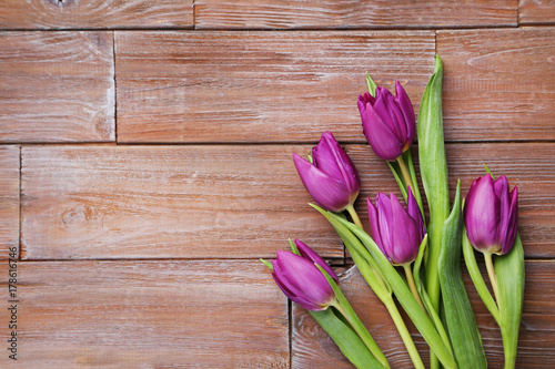 Bouquet of tulips on a brown wooden table