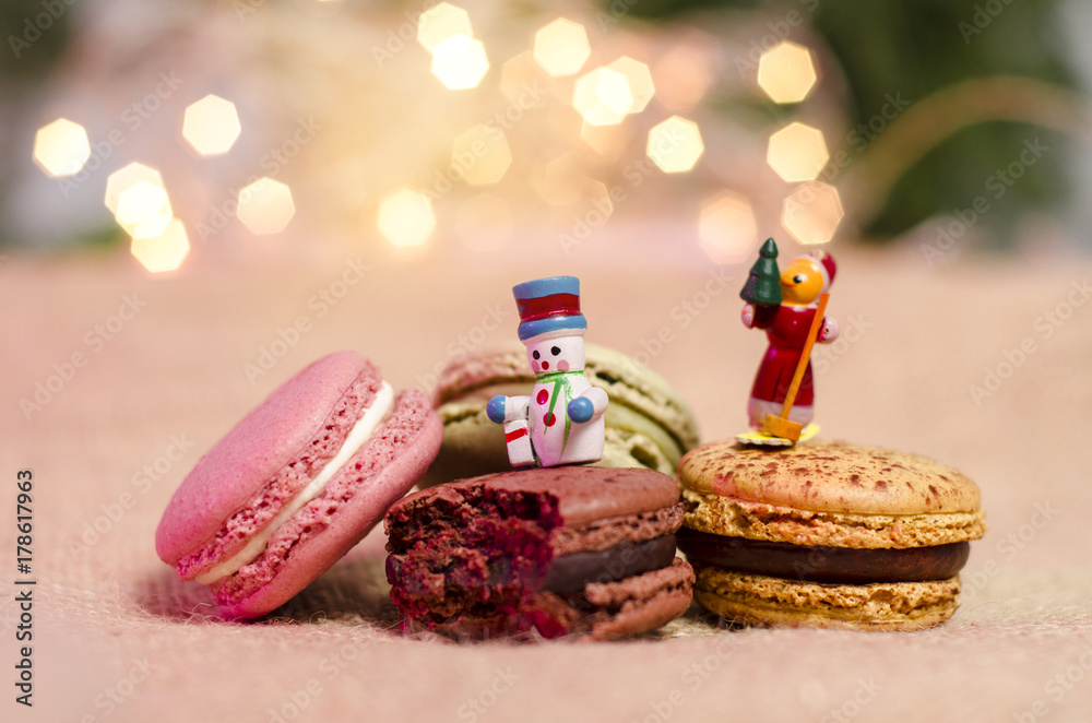 Gorgeous Christmas cookies, bokeh background, little wooden figurines of snowman on macaroons