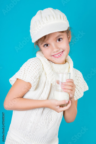 Beautiful little girl with glass of milk