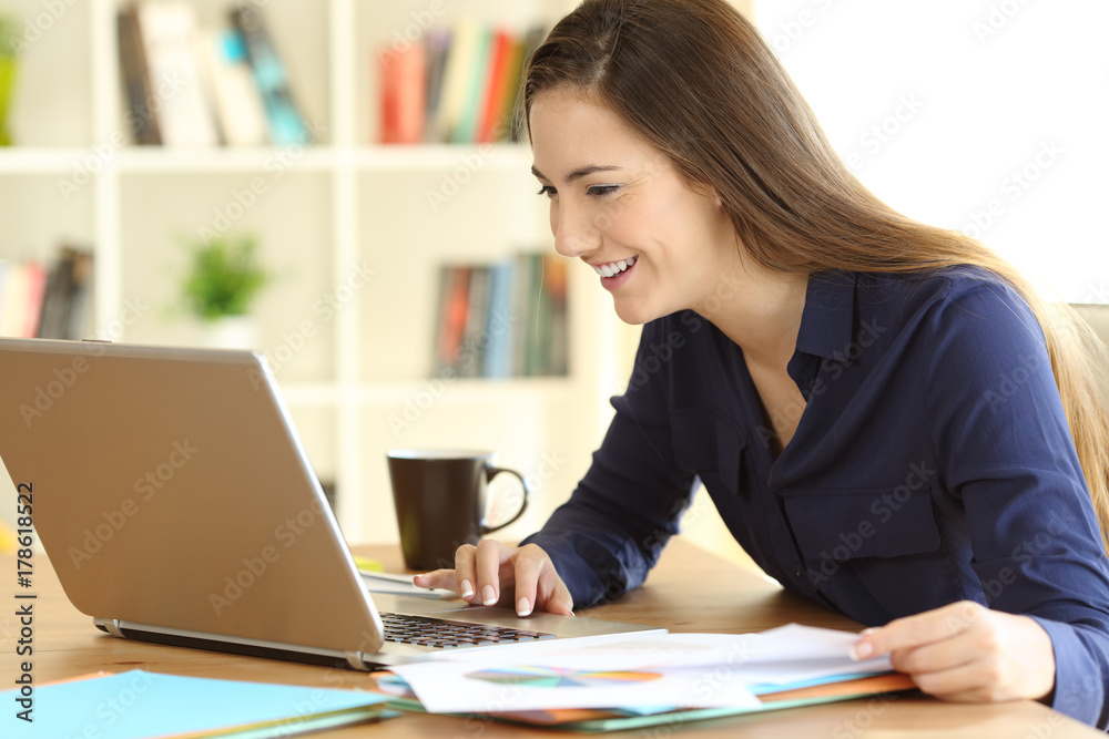 Freelancer working on line with a laptop at home Freelancer working on line with a laptop at home
