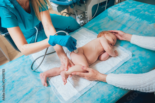 Doctor and little boy patient. Ultrasound equipment. Sonography. Hip dysplasia