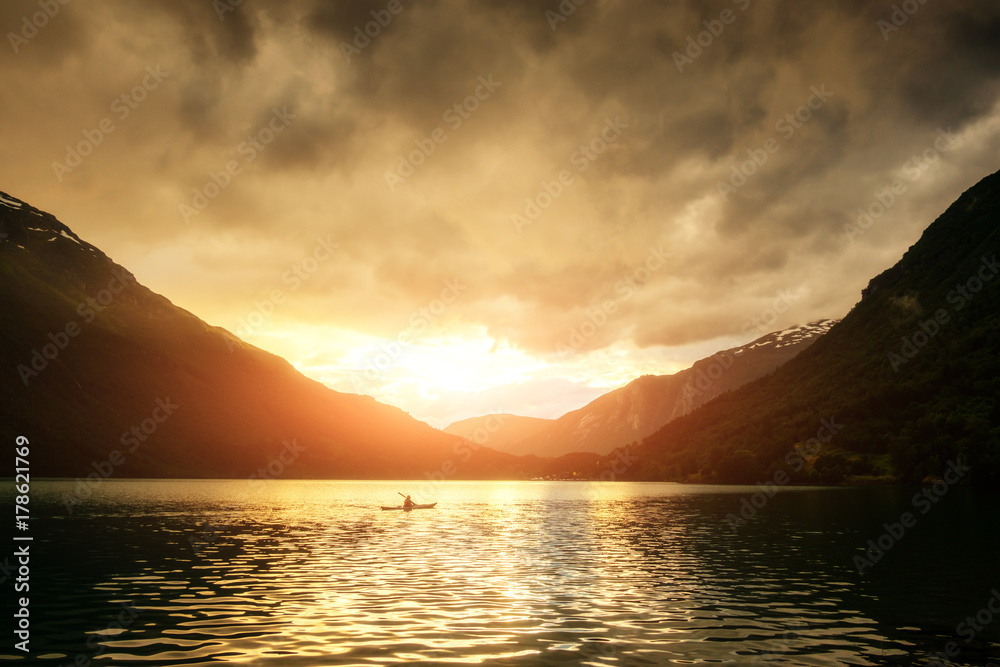 Alone kayaker in the norwegian fjord
