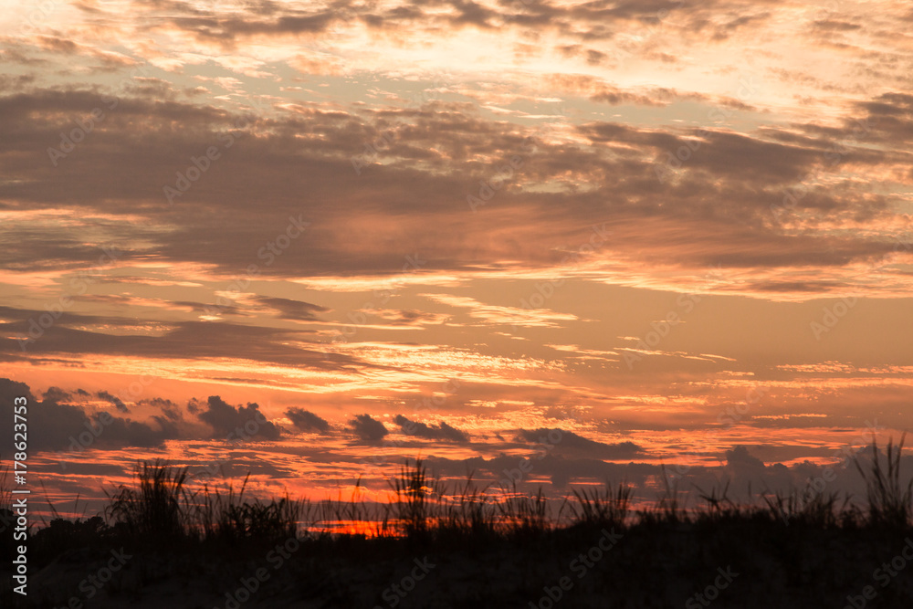 fiery sky beach sunset silhouette