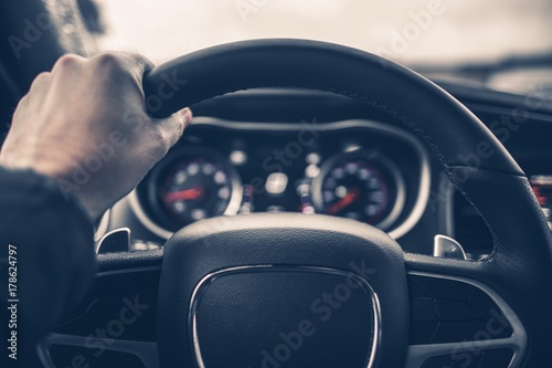 Tablou canvas Hand on Car Steering Wheel