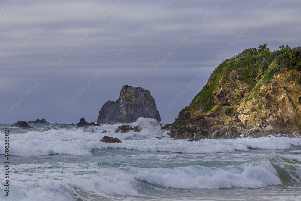 Glasshouse rocks at Narooma ocean coastline in stormy weather Glasshouse rocks at Narooma ocean coastline in stormy weather