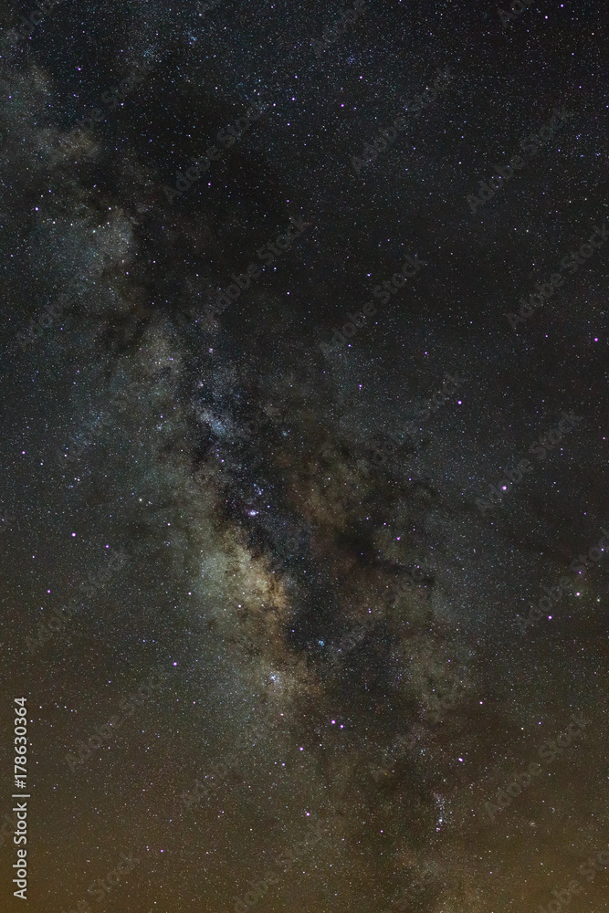 Starry night sky, Milky way galaxy with stars and space dust in the universe, Long exposure photograph, with grain. Starry night sky, Milky way galaxy with stars and space dust in the universe, Long exposure photograph, with grain.