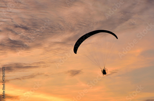 Paragliding  flying on the sky cloud sunset background,one man show paragliding