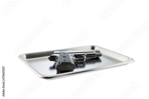 Pistol / Pistol on stainless tray on white background.