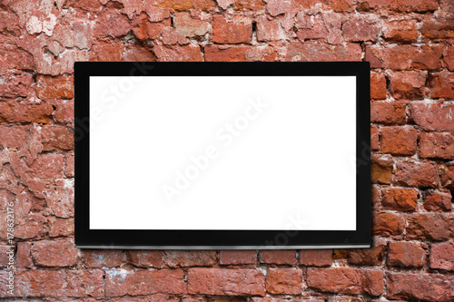 Modern TV screen on brick wall background